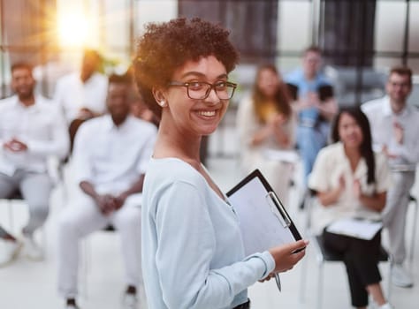 Selective focus of young businesswoman together with interracial colleagues during seminar