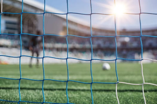 Football goal post with net, back view. Association football goal on the field