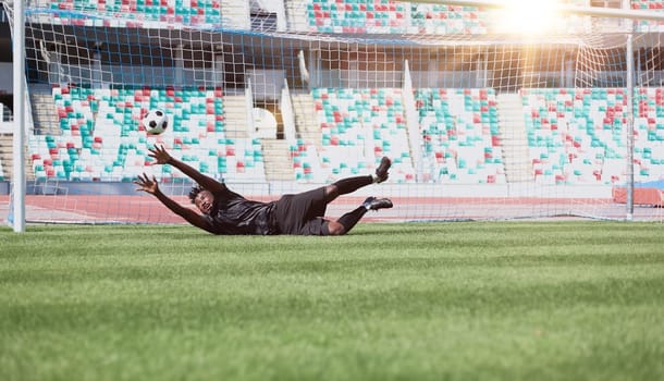 Football goalkeeper catches the ball in the stadium. game concept