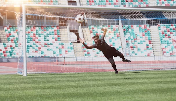 Football goalkeeper catches the ball in the stadium. game concept