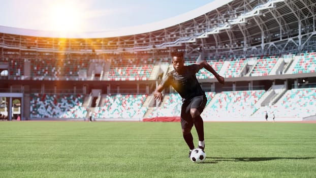 African American man playing football on the stadium field.