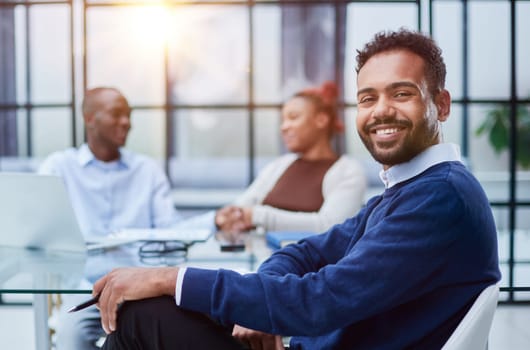 Portrait of African American businessman sitting at desk in an office