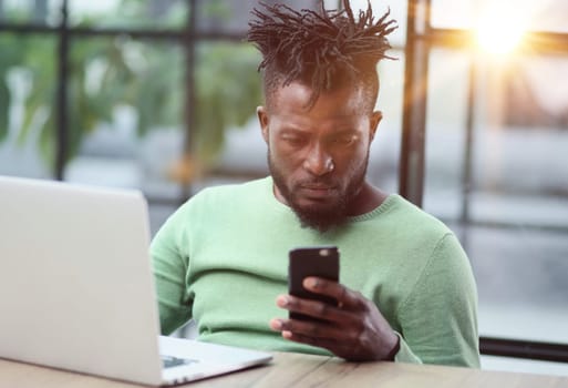 Black businessman talking on cell phone at office