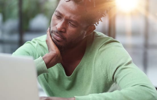 Young businessman holding his head and pondering