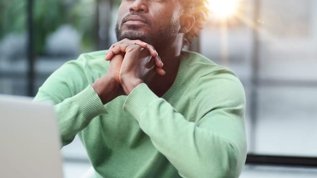Young businessman holding his head and pondering