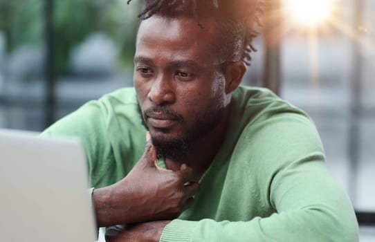 Young businessman holding his head and pondering