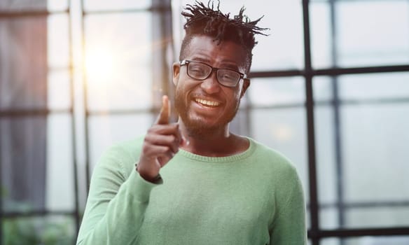 Young afro american worker man points finger at you with a confident expression