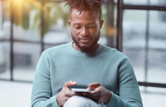 african american businessman using phone mobile corporate apps at workplace texting sms.