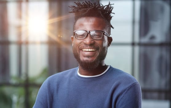 Portrait of a smiling CEO at workplace in a modern office in casual wear with glasses