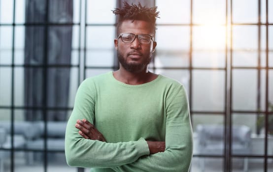 Mature cheerful african american executive businessman at workspace.