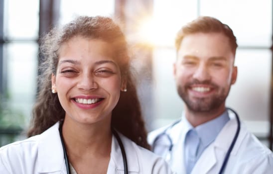 female doctor and male doctor stand in the lobby of the hospital