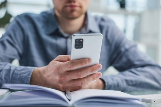 businessman professional executive holding mobile working at desk with smartphone.