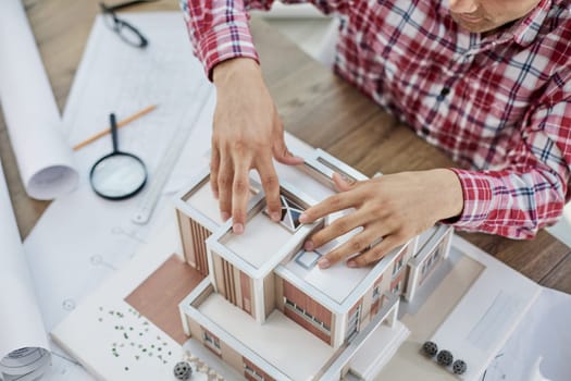 Close up view og real estate agent with house model. home loan and insurance concept.