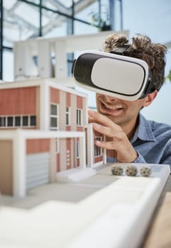looks at the layout of the apartment in virtual reality glasses.