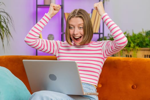 Oh my God Wow. Surprised brunette woman use laptop computer receive good news message shocked by sudden victory celebrate lottery jackpot win purchases online shopping at home. Lifestyle technologies
