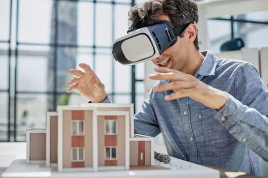 looks at the layout of the apartment in virtual reality glasses.