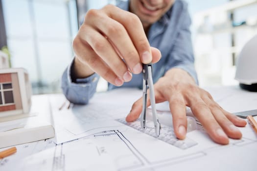 Young handsome architect engineer working on design plan
