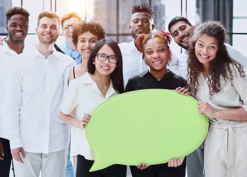 Business team consisting of young business people standing with a comment