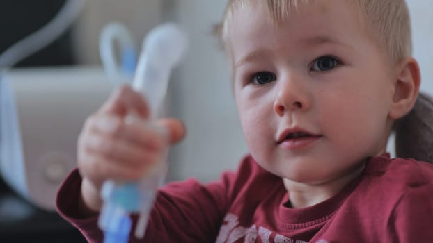 Funny boy breathing through an inhaler mask
