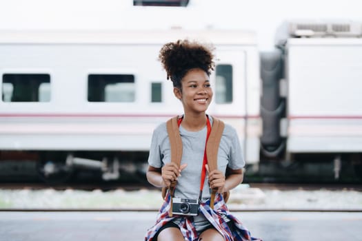 Tourists african american are showing happy expressions while waiting for their journey in the train station