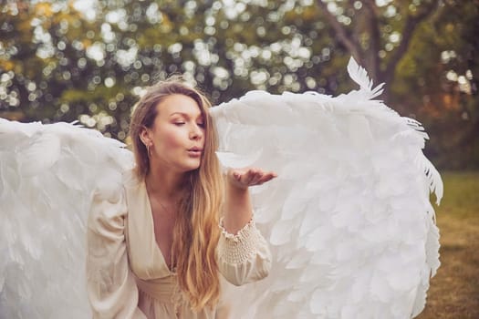 Olstrup, Denmark, June 6, 2023: Beautiful girl dressed as an angel in the garden