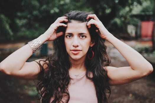 Close up of Latin American girl face looking and smiling at the camera. Portrait of attractive latin girl smiling outdoors. Young nicaraguan woman smiling at camera