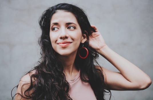 Young nicaraguan woman smiling at camera outdoors. Close up of Latin American girl face looking and smiling at the camera. Portrait of attractive latin girl smiling outdoors