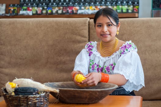 copyspace of farmer from otavalo ecuador smiling at camera shelling corn freshly picked from the field. High quality photo