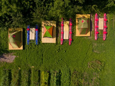 Top view of camp of tourists with tents on the river bank.