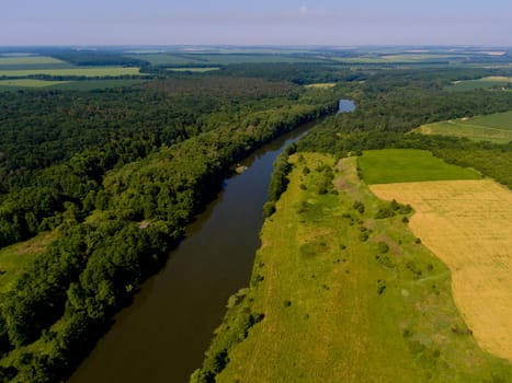 Aerial view of fields, forest, river, a beautiful landscape of nature.