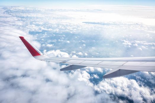 Wing of an airplane on the blue sky in the morning