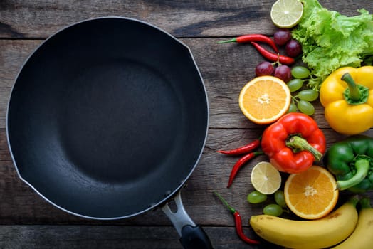 fresh vegetables and fruits for fitness dinner on wooden background top view, food concept