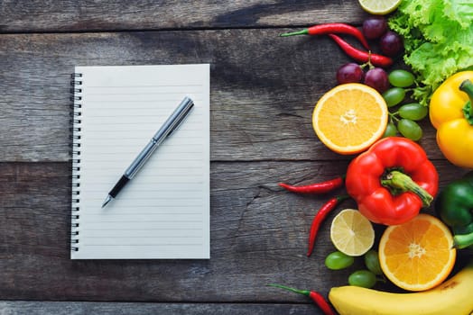 fresh vegetables and fruits for fitness dinner on wooden background top view, food concept