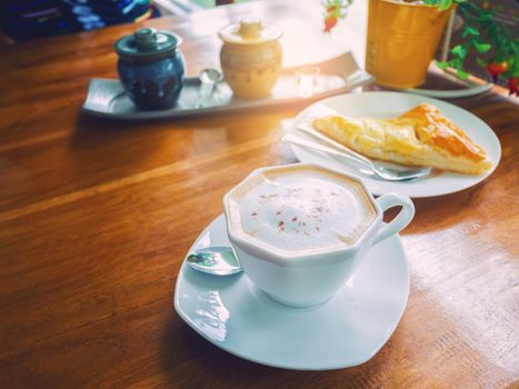 coffee with chicken pie on wood table