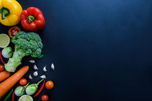 Healthy food concept of fresh organic vegetables and wooden desk background. Ingredients top view