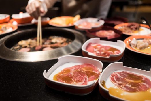 Raw beef and pork slice on grille for barbecue or Japanese style yakiniku