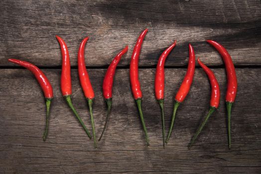 Red chilli on dark wooden table background. food concept