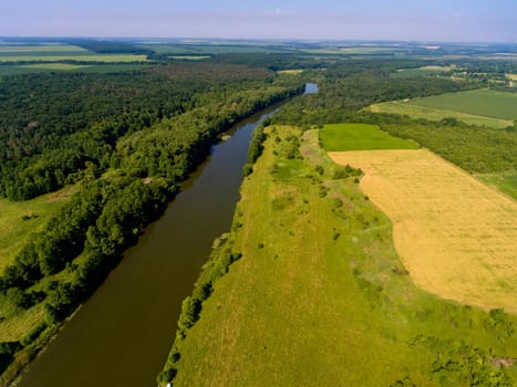 Aerial view of fields, forest, river, a beautiful landscape of nature.