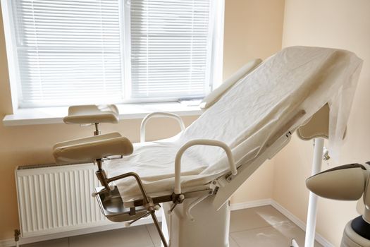 Gynecological chair in the clinic. Gynecology room, medical instruments, interior of the genicological clinic