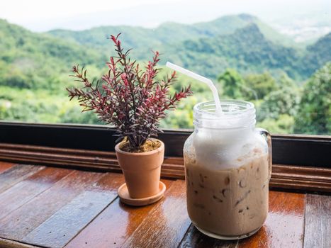 Iced coffee on table with mountain view background