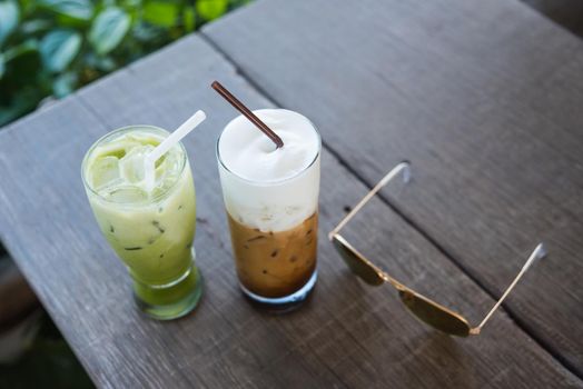 ice coffee and green tea on wood table green background