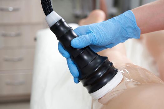 Body care. Spa treatment. Ultrasound cavitation body contouring treatment. Woman getting anti-cellulite and anti-fat therapy in beauty salon