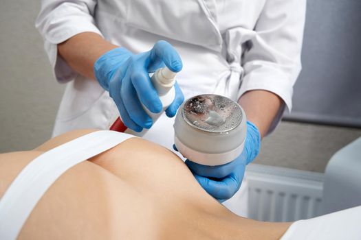 Hardware cosmetology. Body care. Spa treatment. Doctor disinfecting maniple before treatment in beauty salon.