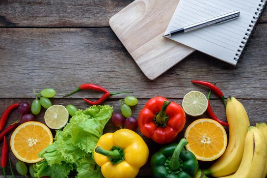 fresh vegetables and fruits for fitness dinner on wooden background top view, food concept