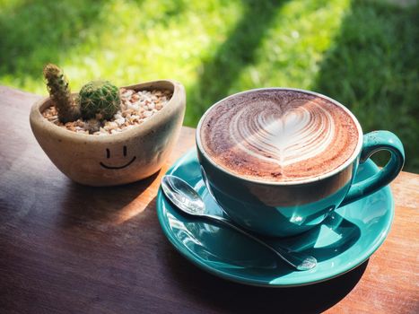 Vintage color,coffee cup with heart shape latte art on wood table