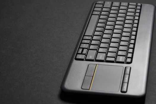 Computer keyboard over a black background with copy space