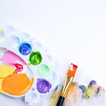 Design concept - Preparing for Easter celebration, painting Easter eggs with colorful Acrylic pigment color dyestuff in palette, top view, lifestyle.