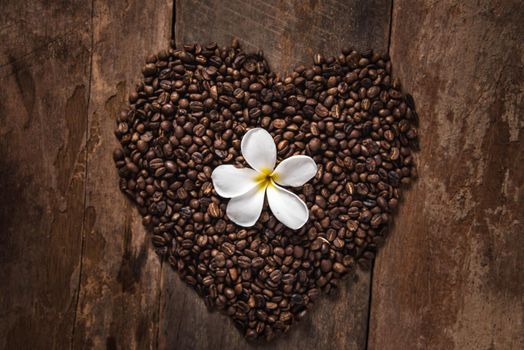 coffee cup and coffee bean on wooden table