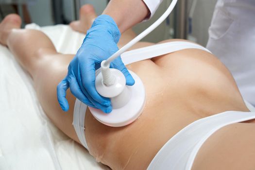 Hardware cosmetology. Body care. Spa treatment. Ultrasound cavitation body contouring treatmentWoman getting anti-cellulite and anti-fat therapy in beauty salon.