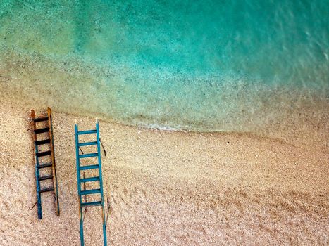 Top view of a beautiful tropical empty beach with two ladders for tourist boat.